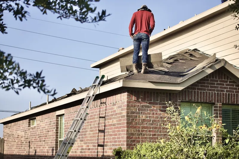Professional roofer working on a residential roof in Pondsville